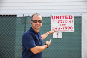Louie Adamo Pointing at United Rent-A-Fence Sign